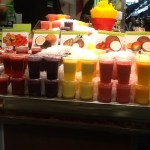 Fresh-squeezed juices lined up at a stall in La Boqueria.