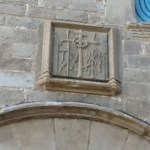 Inquisition Headquarters. For those who could t read, the symbols of torture depicted on the overhead plaque made it clear.